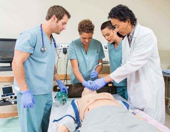 Doctor Instructing Nurses In Hospital Room